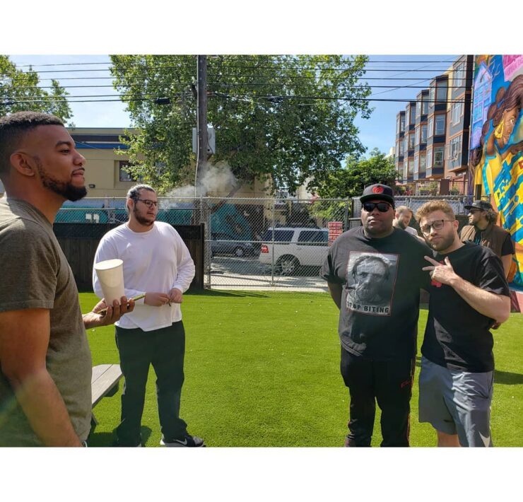 4 men in front of the camera