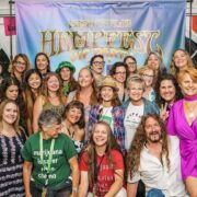 cannabis world news image of crowd of woman posing in front of Hempfest banner with Dave Mesford leaning down in the front