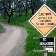 cannabis world news .image of road and sign that says Caution Vietnam Vet Lives Here and caution