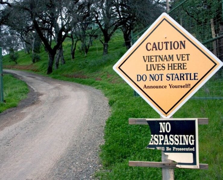 cannabis world news .image of road and sign that says Caution Vietnam Vet Lives Here and caution