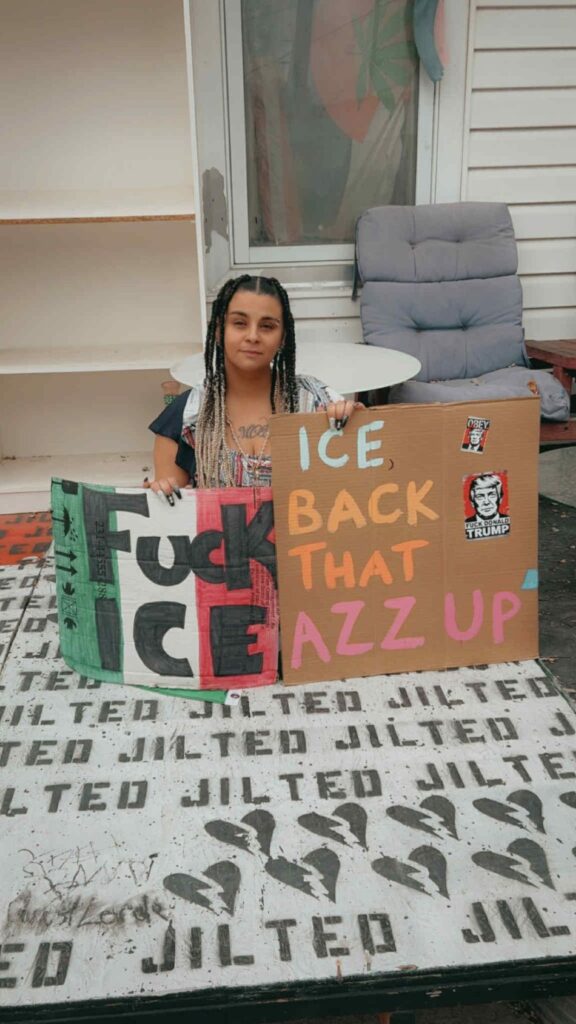 cannabis world news commentary image of woman holding political, signs