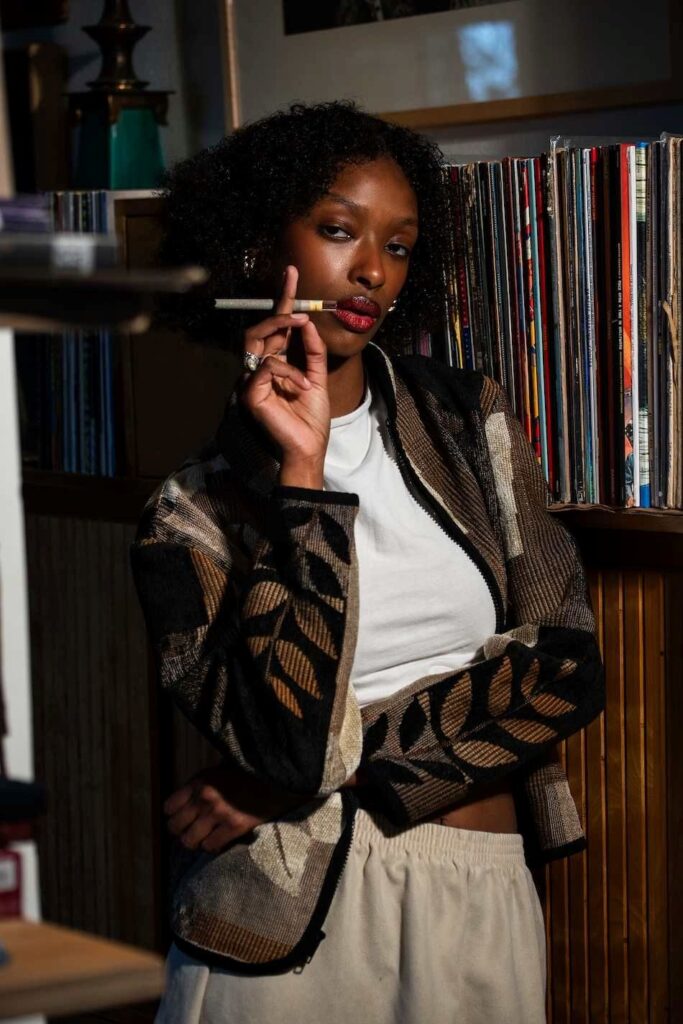 cannabis world news black woman smoking a pre-roll joint
